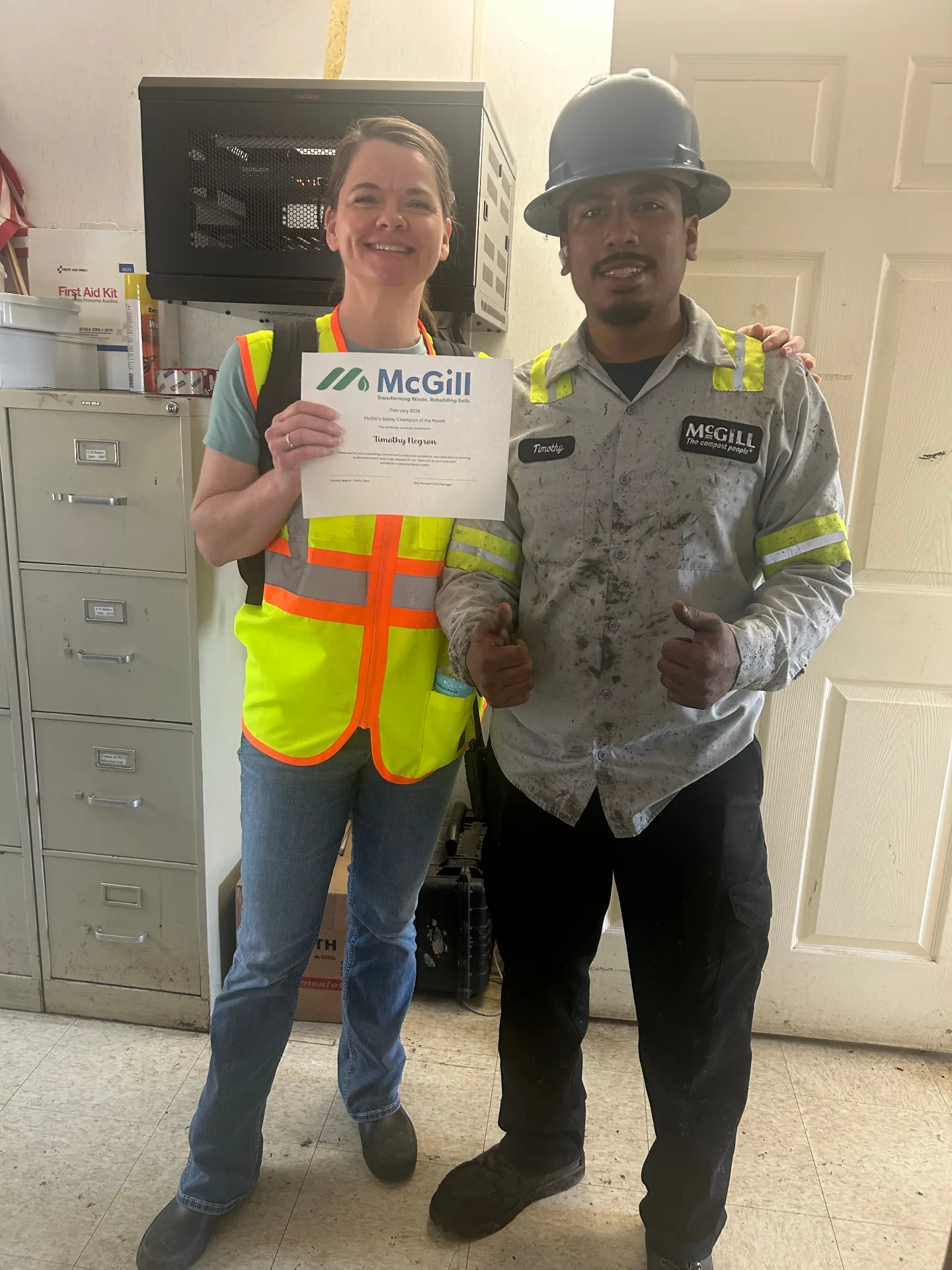 McGill manager presenting Safety Champion certificate to team member