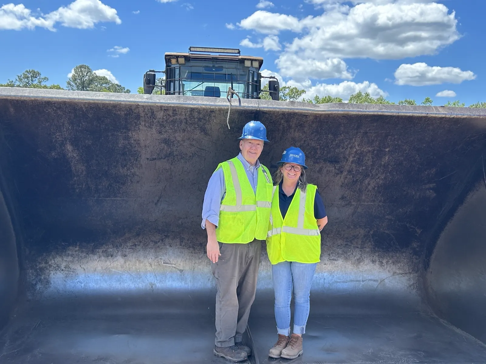 Two McGill team members in safety vests at a composting facility