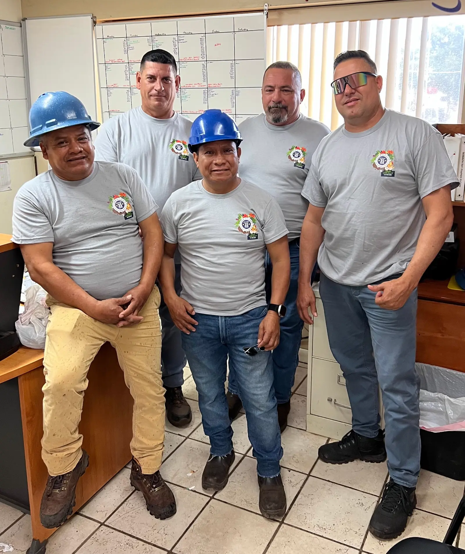 McGill team members in 35 Years anniversary t-shirts and hard hats posing together