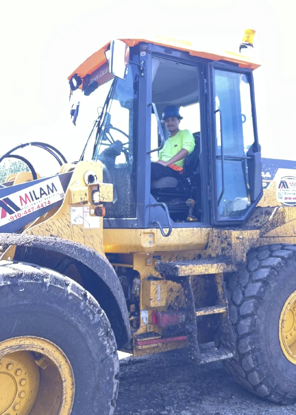 McGill operator sitting in the cab of a heavy wheel loader on a sunny day