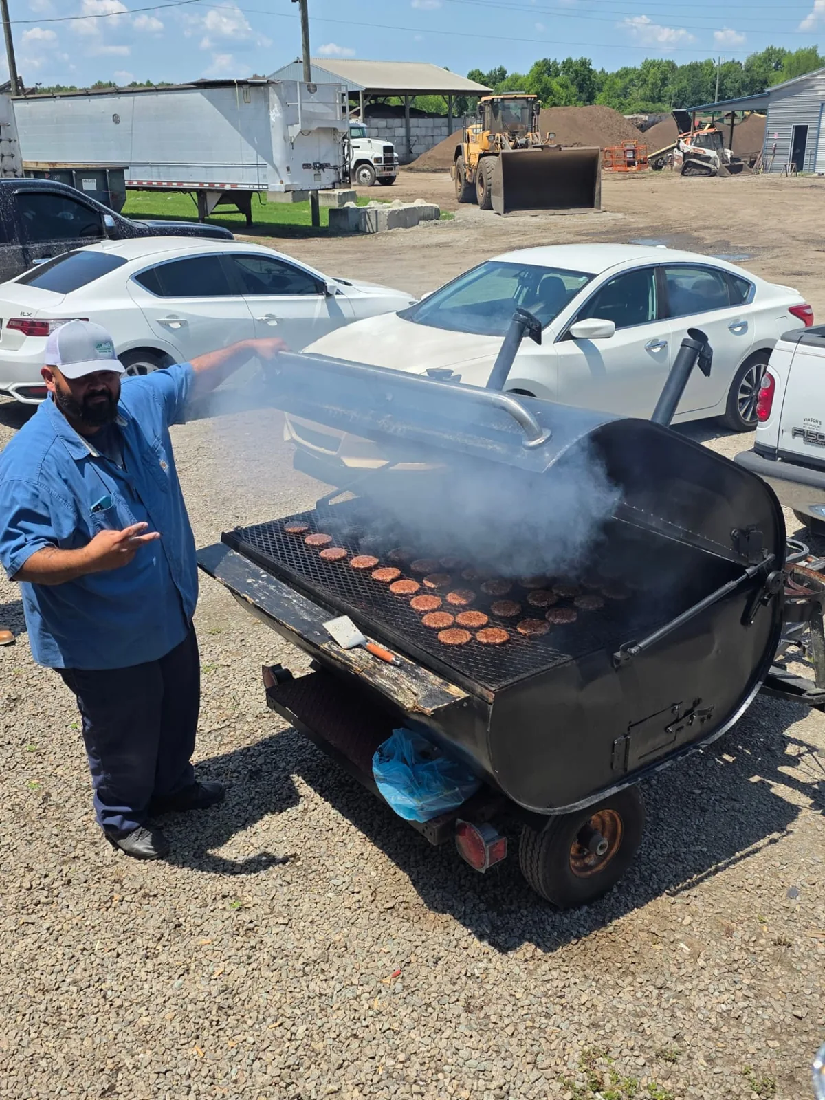McGill team member grilling burgers at a company cookout