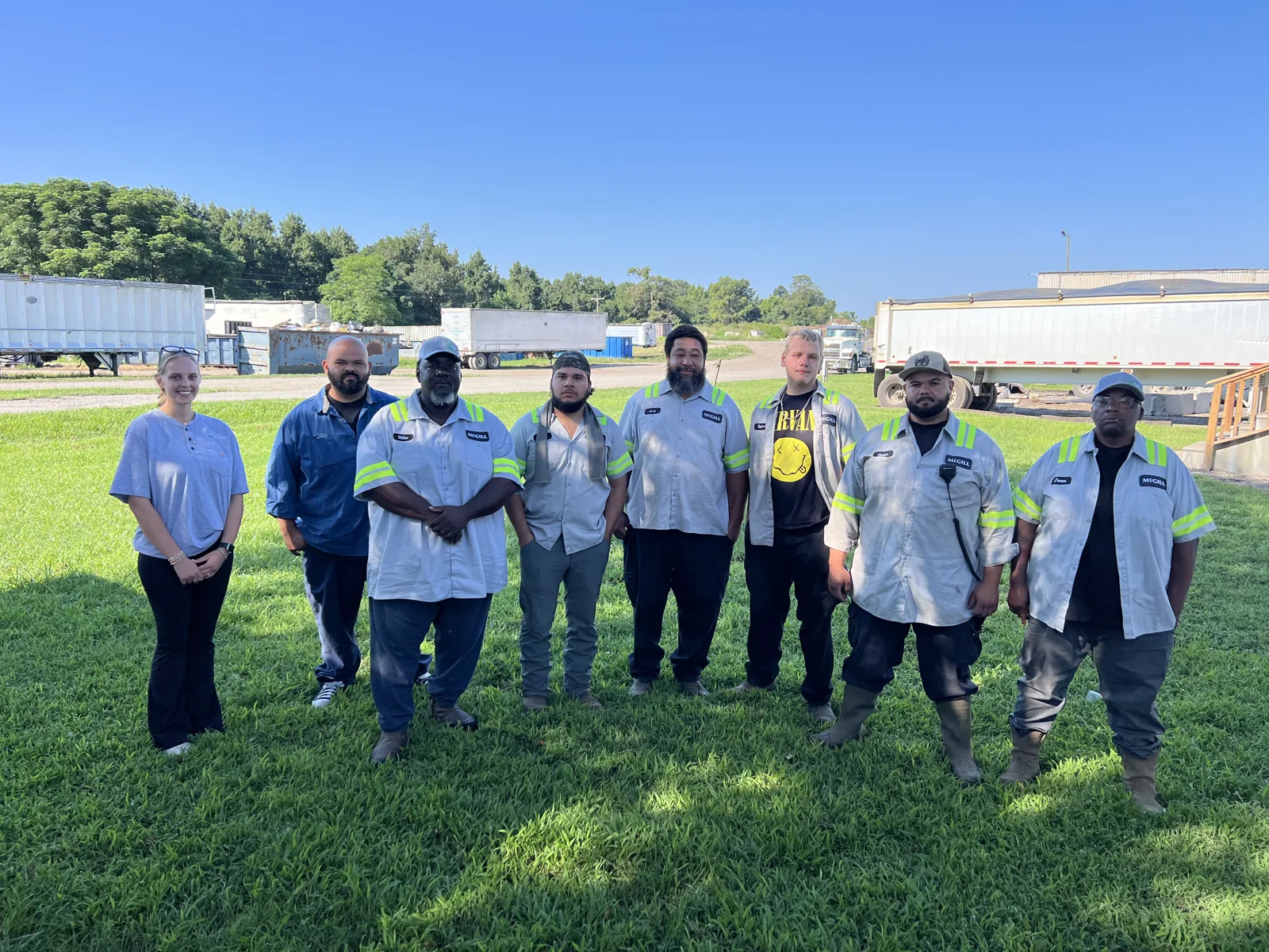 McGill plant team standing together on the grass for a group photo on a sunny day