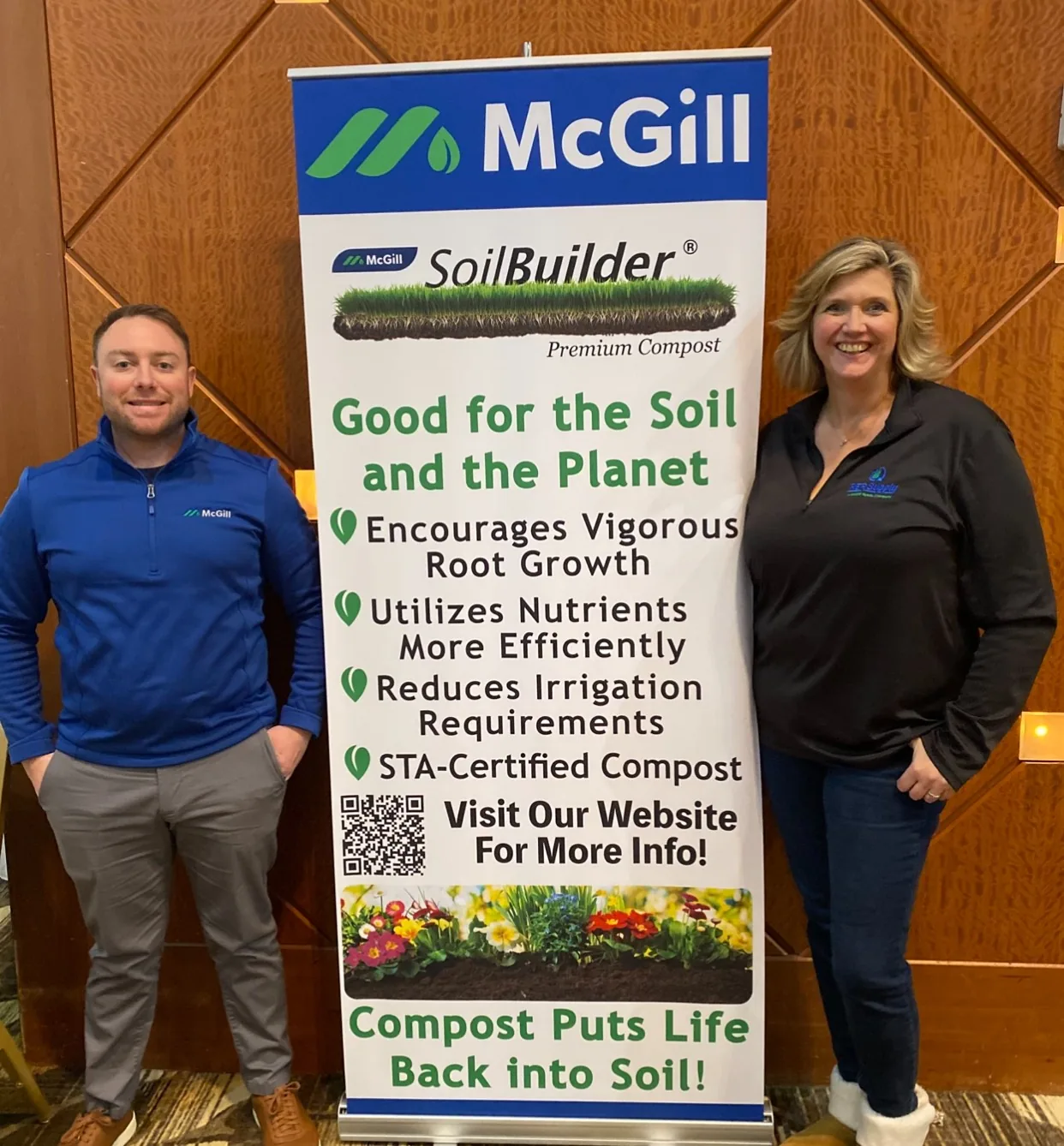 McGill staff at a SoilBuilder premium compost trade show banner